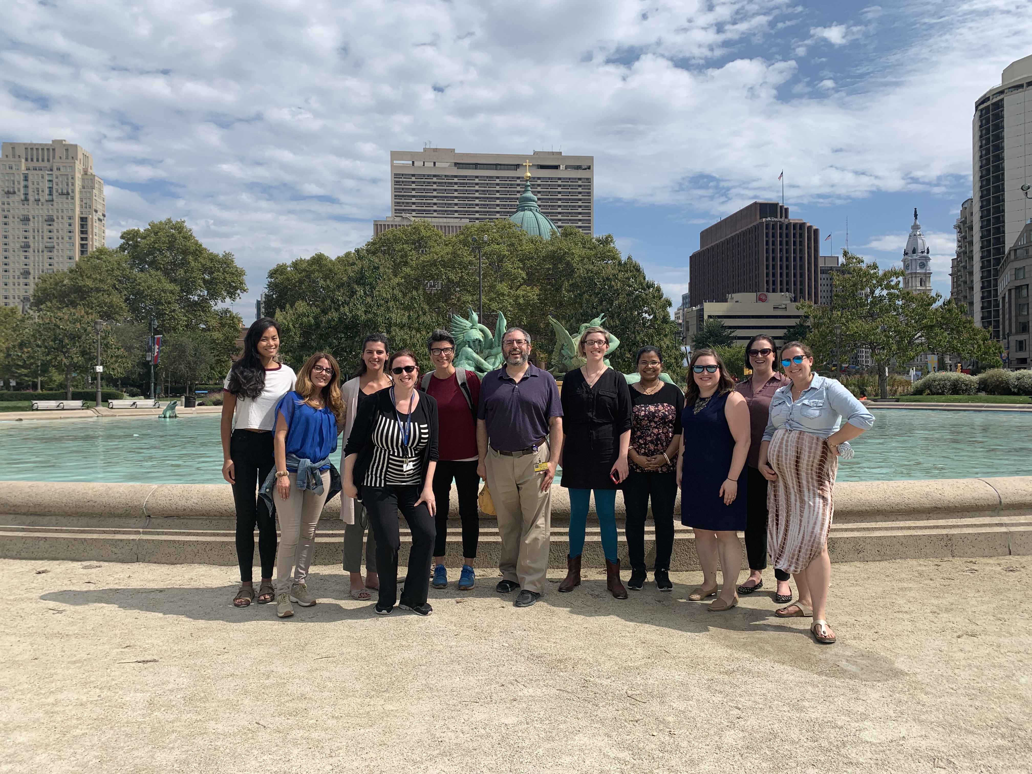 Group of postdocs in front of fountain